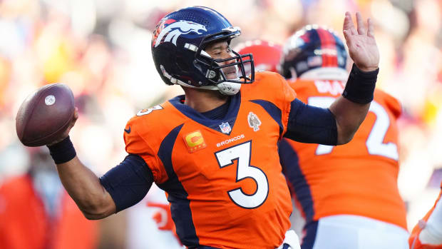 Russell Wilson brings the ball back with one arm behind him to throw it